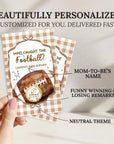 a hand holding a personalized football-themed baby shower invitation.