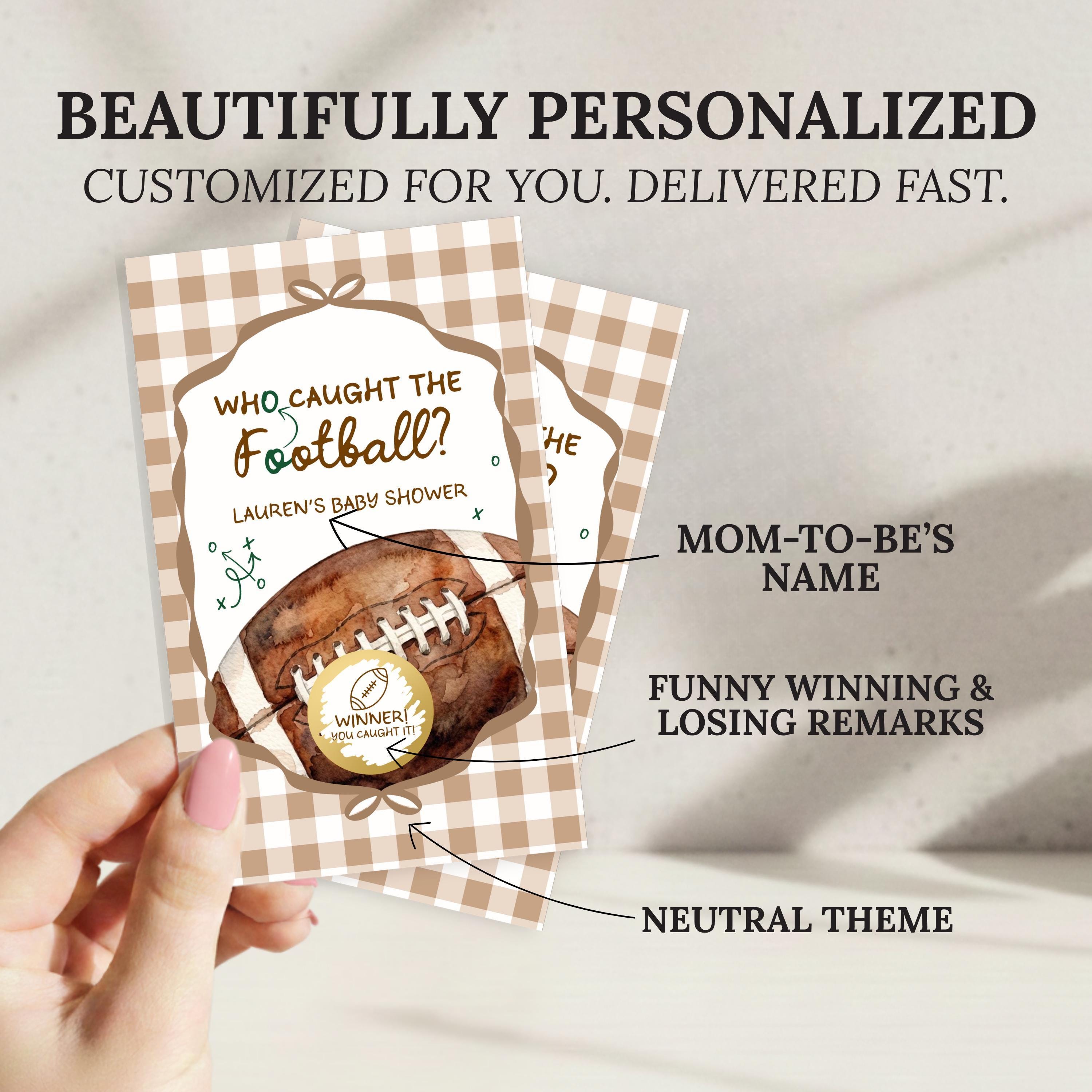 a hand holding a personalized football-themed baby shower invitation.