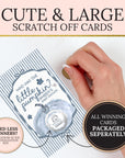 a hand holding a large scratch-off card with a pumpkin design, and there is a smaller sign next to it that says "Needless Winners? Let us know in the Personalization Box".