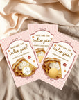 Three pink and white baby shower invitations with illustrations of pies and the text "Who has the cute pie?"