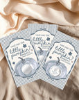 Three identical cards with a pumpkin design and text, placed on a beige fabric background.