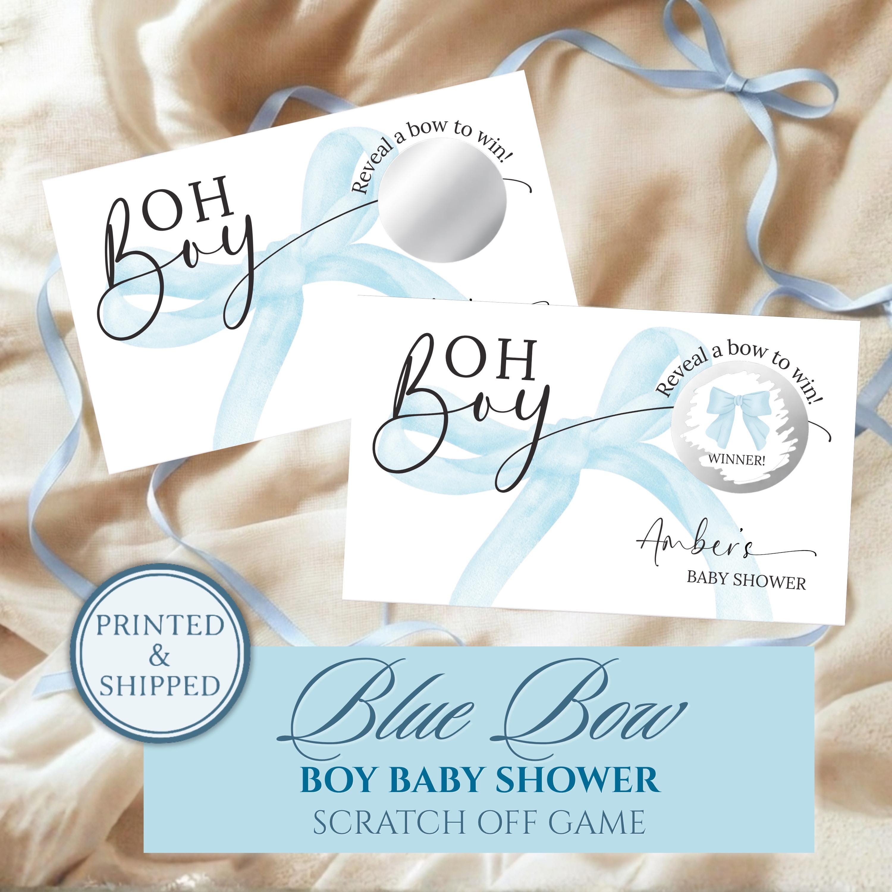 The image is a printed and shipped baby shower invitation with a blue bow design. It features a blue bow on a white background and includes a silver bow on a ribbon. The invitation is for a "Blue Bow Boy Baby Shower" and includes a scratch-off game.