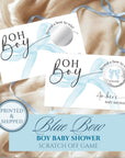 The image is a printed and shipped baby shower invitation with a blue bow design. It features a blue bow on a white background and includes a silver bow on a ribbon. The invitation is for a "Blue Bow Boy Baby Shower" and includes a scratch-off game.